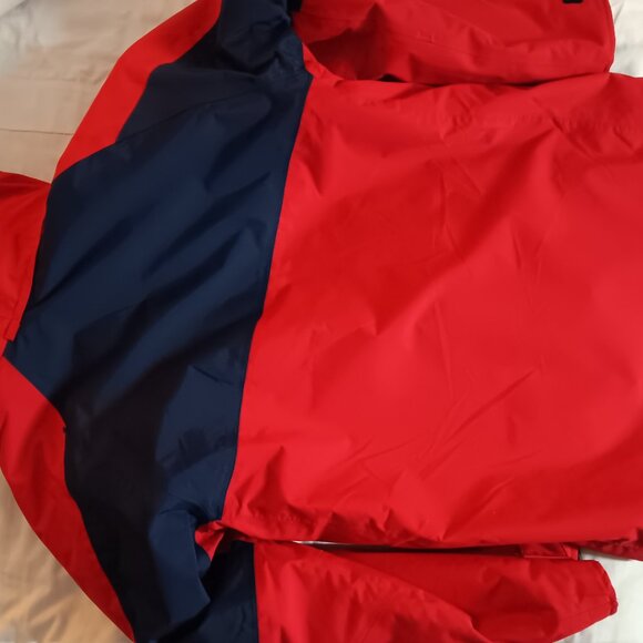 The iconic Abercrombie & Kent expedition red winter coat with blue lining. - Picture 7 of 10